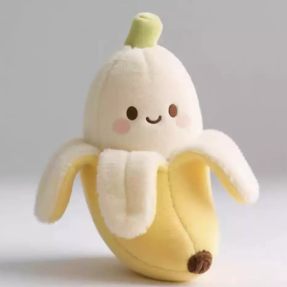 Cute plush toy shaped like a banana with a smiling face on a light gray background