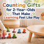 Two toddlers playing with a wooden number train, bead maze, and fish number puzzle in a warm indoor playroom