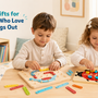 Curious 4-year-old children using building, logic, and drawing toys in a bright home playroom