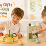Three-year-old children playing with a wooden cake set, coffee machine, and cash register in a bright home playroom