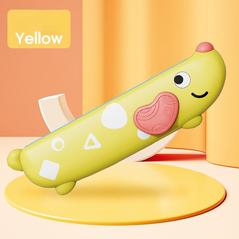 Yellow toy banana with a smiley face on a yellow platform against an orange background