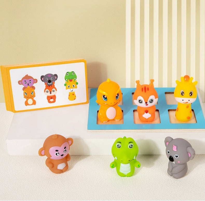 Set of colorful animal figurines on a white surface with a beige wall in the background.