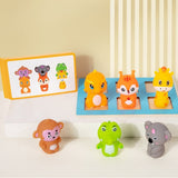 Set of colorful animal figurines on a white surface with a beige wall in the background.