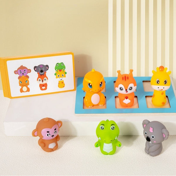 Set of colorful animal figurines on a white surface with a beige wall in the background.