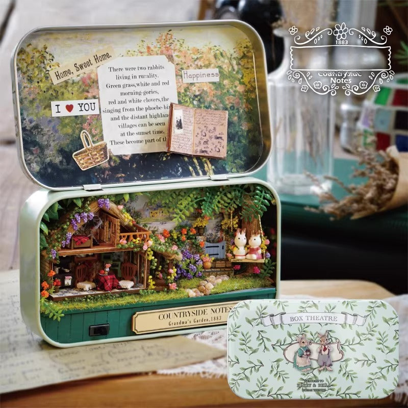 Decorative tin box with miniature scene and 'I Love You' card, placed on a surface.