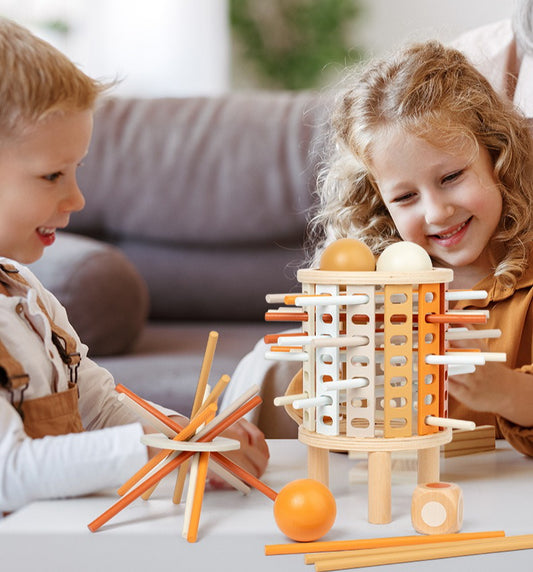 Two children playing with a wooden toy set on a table.