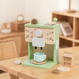 Toy coffee machine with a cup on a wooden table