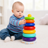 Baby playing with a colorful stacking toy on a light-colored floor.