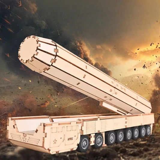 Wooden model of a military vehicle with a large cannon against a dramatic sky background