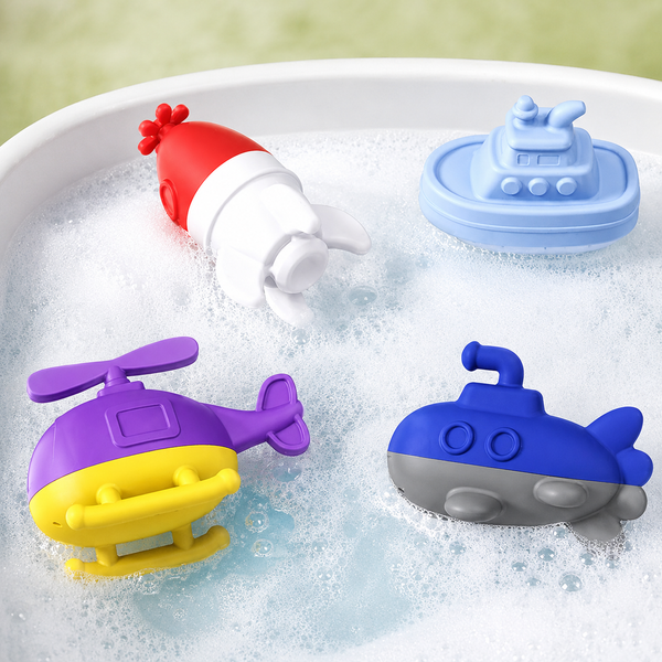Colorful bath toys including a helicopter, submarine, and boat on a white tray with water.