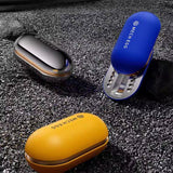 Three small devices in blue, yellow, and silver on a textured surface