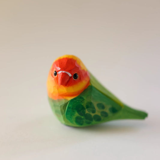 Colorful ceramic bird figurine on a plain background