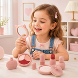 Little girl pretending to use a silicone makeup toy set at a play vanity