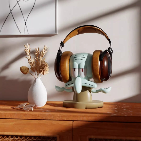 Decorative headphone stand with a cartoon face on a wooden surface