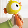 Toy rattle held by a hand with a yellow and orange design