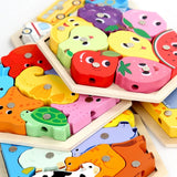 Colorful wooden puzzle with animal and fruit shapes on a white background