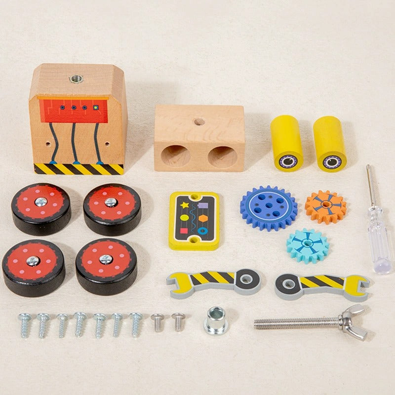 Set of colorful mechanical toys and tools on a beige background
