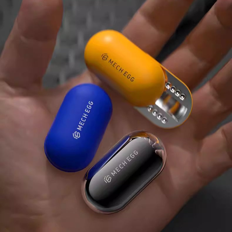 Three MECH EGG products in yellow, blue, and silver on a hand.