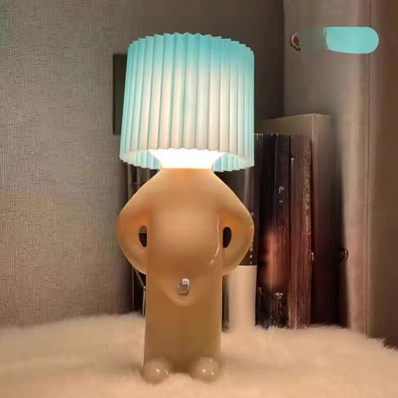 Unusual shaped lamp with a blue gradient shade on a textured surface.