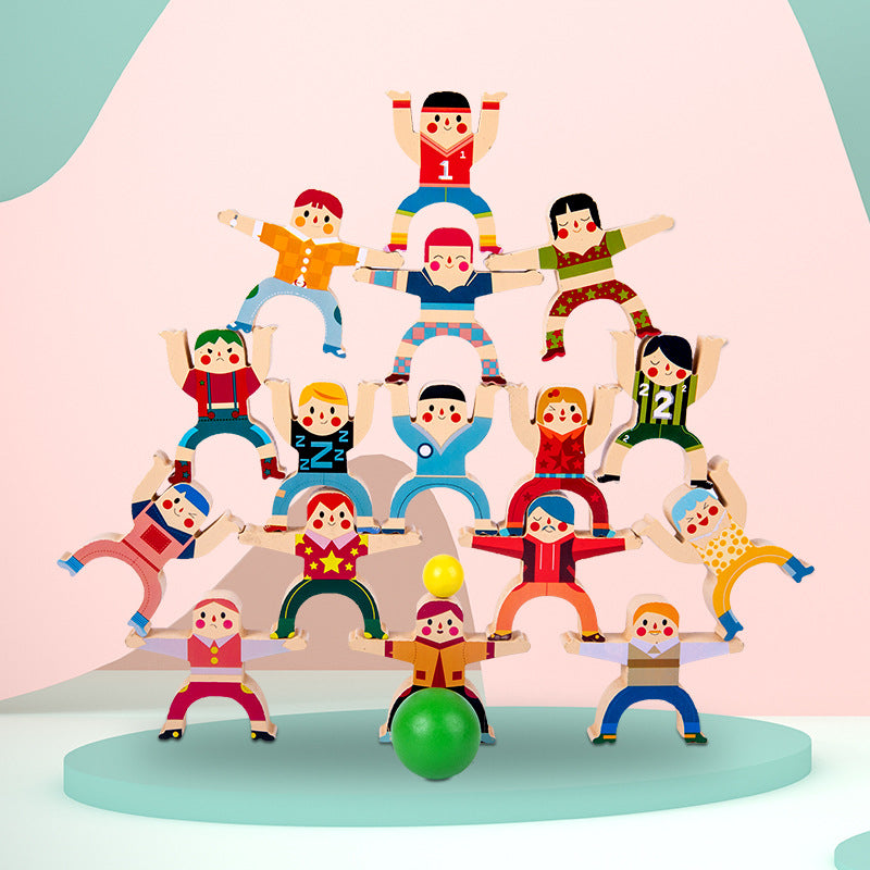 Colorful toy figure pyramid on a light blue platform with a pink background