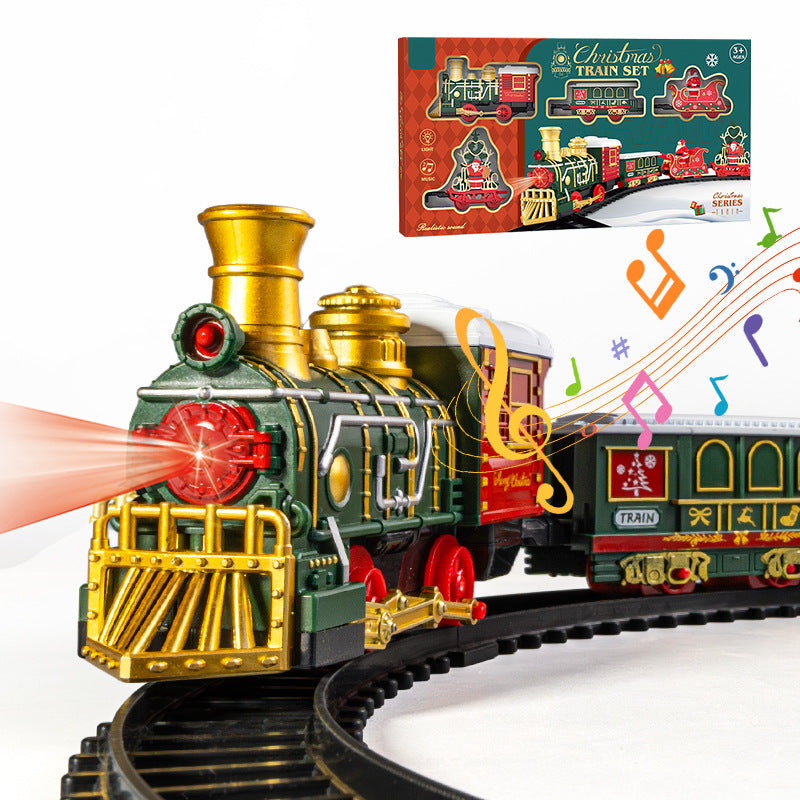 Toy train set with locomotive and cars on a track, including a Christmas-themed packaging in the background.