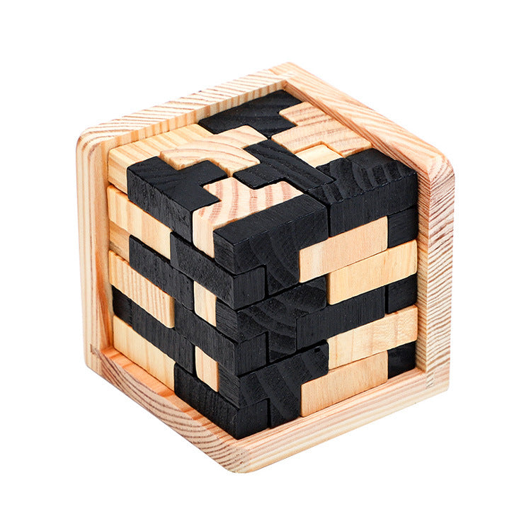 Wooden puzzle cube with black and natural wood pieces on a white background