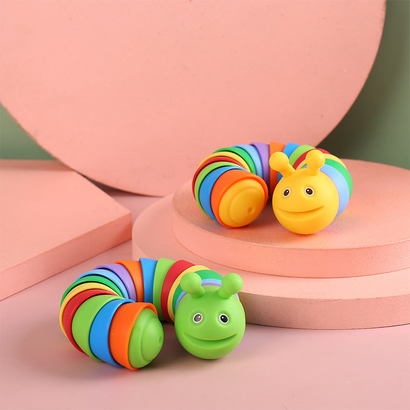 Colorful caterpillar-shaped toys on a pink and green background