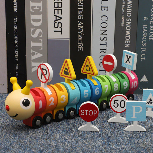 Colorful toy caterpillar with traffic signs on a textured surface