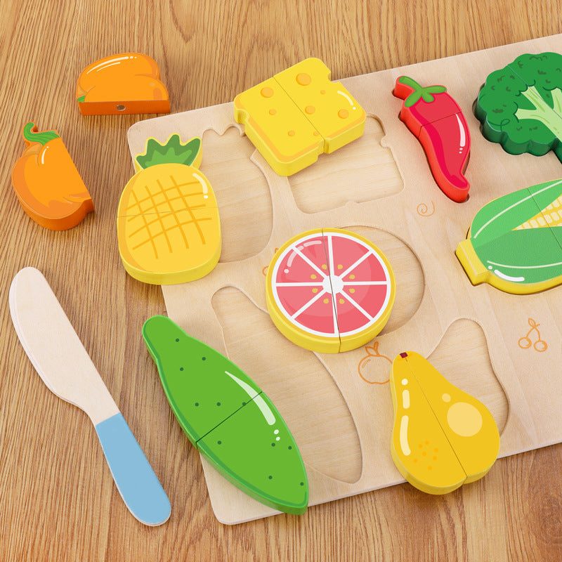 Wooden toy cutting board with colorful fruit and vegetable shapes on a wooden surface.