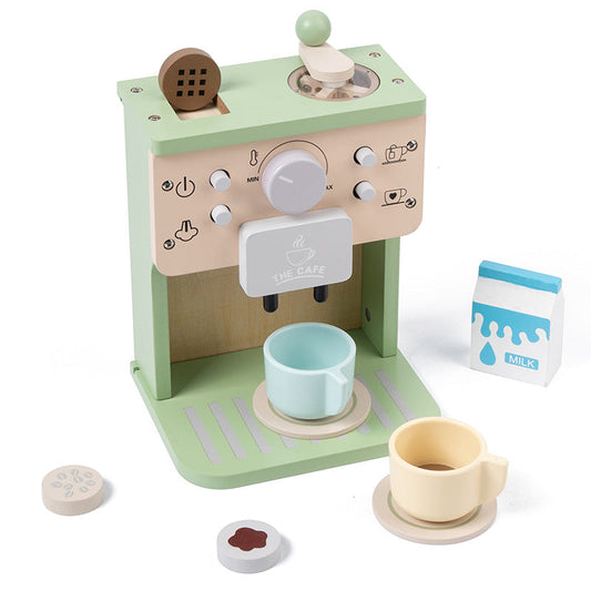 Wooden toy coffee machine with cups and milk container on a white background