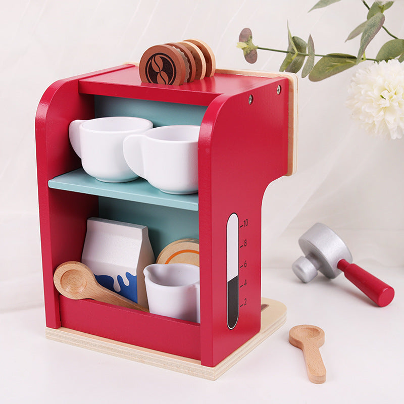 Red toy kitchen set with shelves containing white bowls and wooden utensils on a light background.