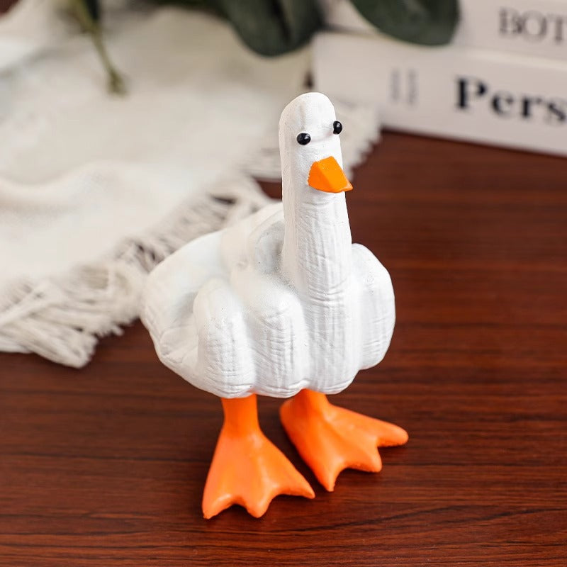 Funny white duck resin figurine displayed on a desk as a novelty gag gift.