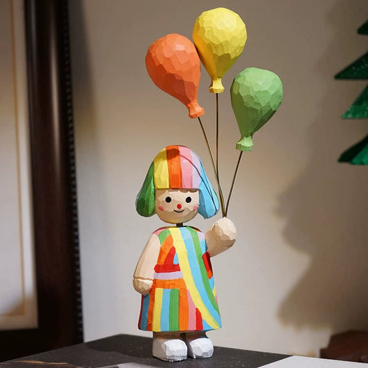 Colorful clown figurine with balloons against a neutral background