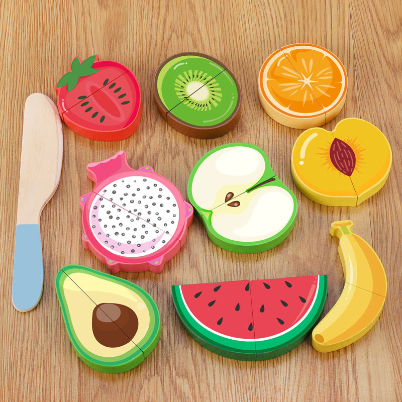 Set of colorful fruit-shaped cutters on a wooden surface