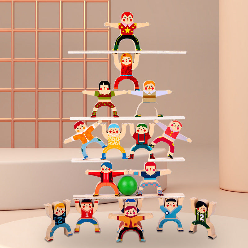 Set of colorful wooden toy figures on a white surface with a pink grid background