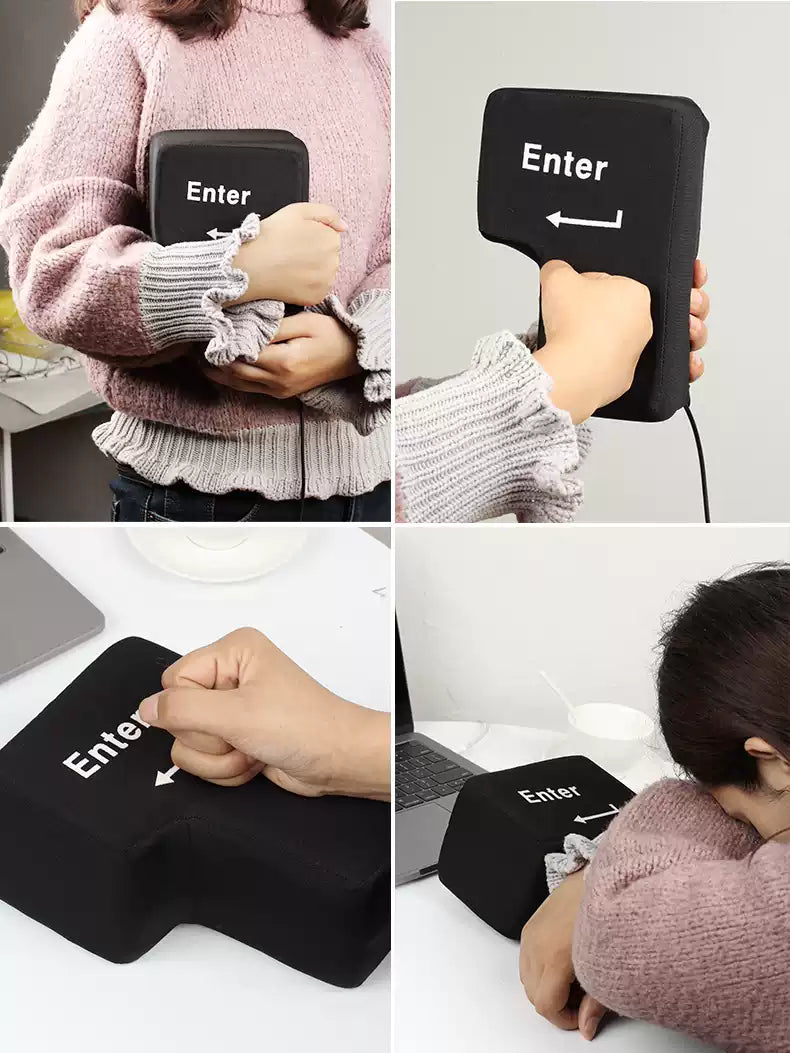Black 'Enter' key pillow held by a person and used as a neck pillow.