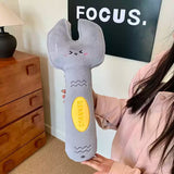 Person holding a plush wrench toy with a 'Stamper' logo in a room with a 'FOCUS.' sign.