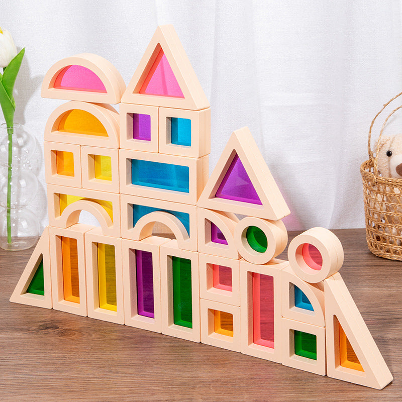 Colorful wooden building blocks on a wooden surface with a white curtain background