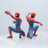 Two Spider-Man action figures on a light gray background