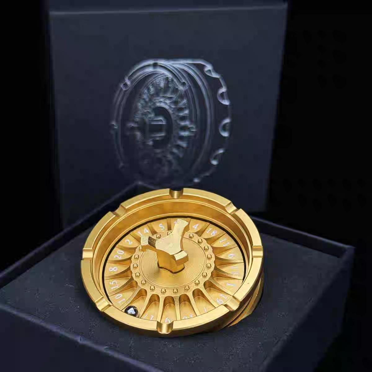 Gold decorative item on a black box with a logo