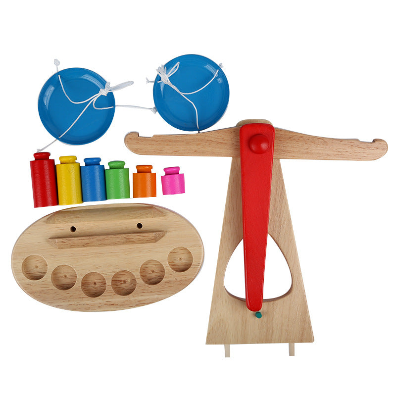 Set of wooden toys including a xylophone, maracas, and other items on a white background
