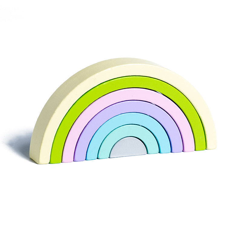 Pastel-colored rainbow-shaped wooden toy on a white background