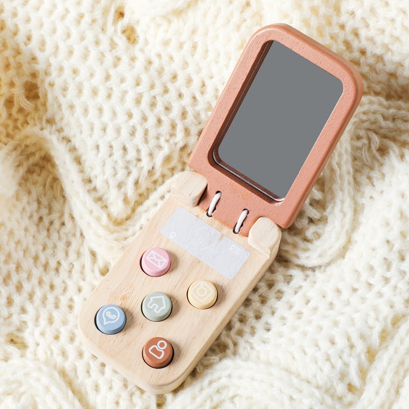 Small electronic device with a screen and colorful buttons on a textured beige background