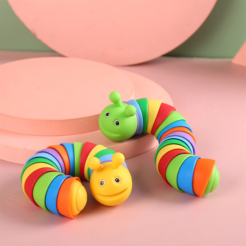 Colorful toy caterpillar on a pink background