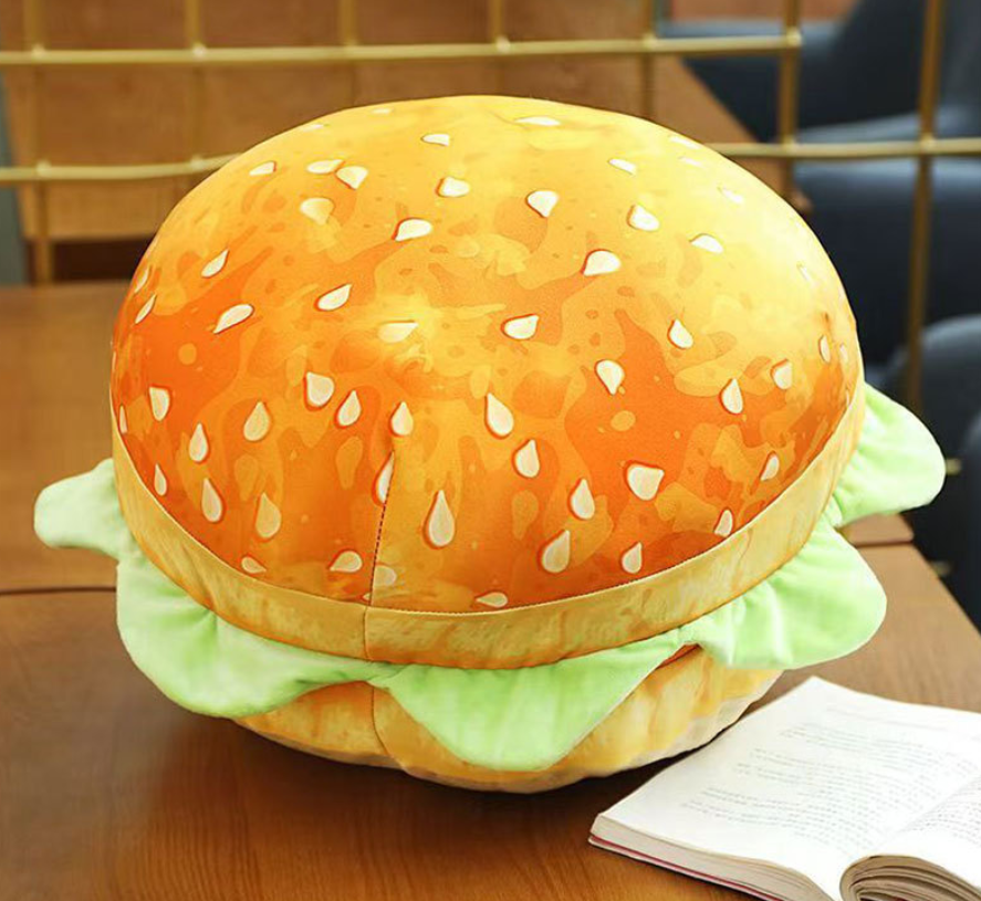 Hamburger-shaped plush toy on a wooden surface
