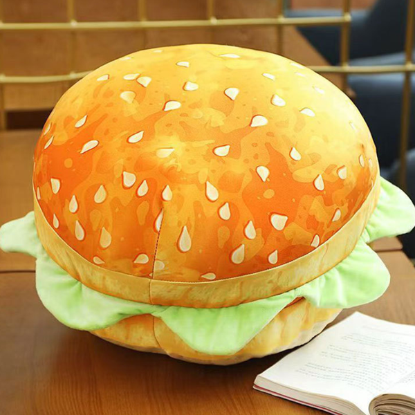 Hamburger-shaped plush toy on a wooden surface