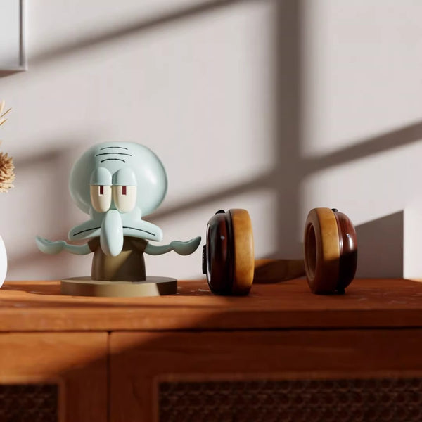 Decorative figurine of a cartoon character on a wooden surface with a neutral background