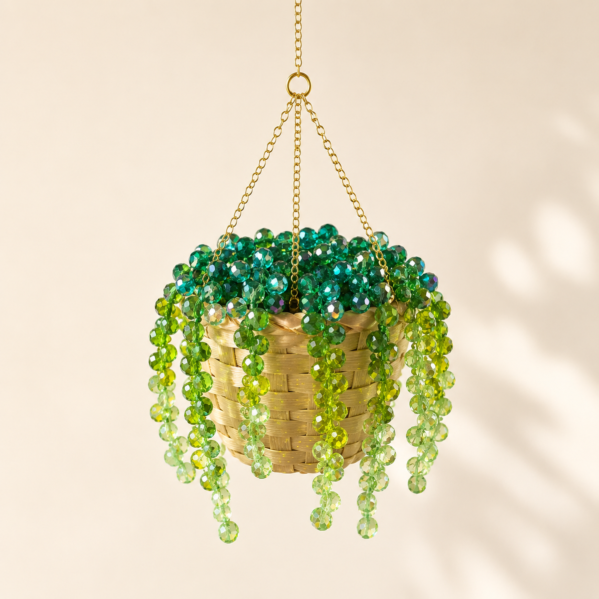 Hanging plant with green beads on a beige background