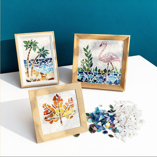 Three mosaic artworks of a palm tree, flamingo, and leaf on wooden frames against a blue background.