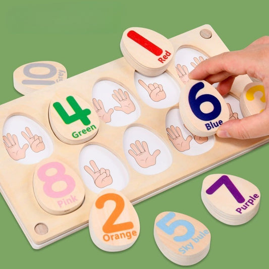 Wooden number puzzle with colorful numbers and hand gestures on a green background